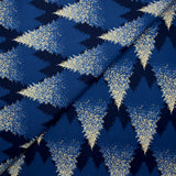 Cotton poplin printed with sparkling fir trees on a midnight blue background