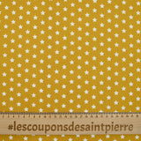 Popeline de coton imprimée étoiles fond moutarde