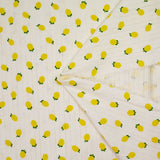Jersey pointelle coton imprimé citron fond blanc cassé