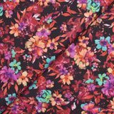 Coton imprimé fleuri graphique rouge, fuchsia et turquoise fond noir