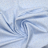 Piqué de coton imprimé pissenlit fond bleu clair