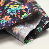 Algodón estampado floral gráfico fondo naranja y morado negro