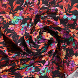Coton imprimé fleuri graphique rouge, fuchsia et turquoise fond noir