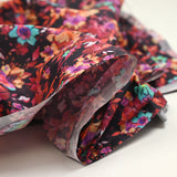 Coton imprimé fleuri graphique rouge, fuchsia et turquoise fond noir