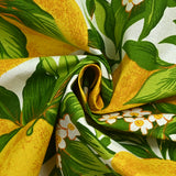 Polycoton imprimé citrons et feuilles vertes fond blanc