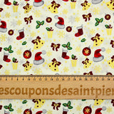 Cotton poplin printed with Santa's hats, socks and holly on an ecru background