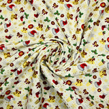 Cotton poplin printed with Santa's hats, socks and holly on an ecru background