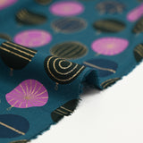 Cotton poplin printed with festive balls and golden flashes on a duck background