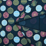 Cotton poplin printed with festive balls and golden sparkles on a navy blue background