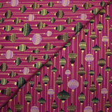 Cotton poplin printed with vintage Christmas baubles on a purple background