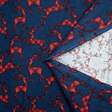 Cotton flannel printed with red deer on navy blue background
