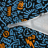 Sergé de coton imprimé graffitis bleu et orange fond noir