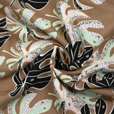 Lin viscose imprimé pluie de monsteras fond marron