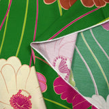 Viscose twill printed with anise and fuchsia flowers on a meadow green background
