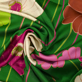 Viscose twill printed with anise and fuchsia flowers on a meadow green background