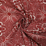 Tejido de algodón con aspecto de lino y estampado arabesco rojo ladrillo.