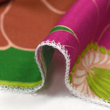 Viscose twill printed with anise and fuchsia flowers on a meadow green background