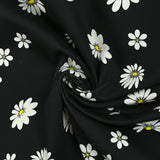 Cotton gabardine with daisy print on black background