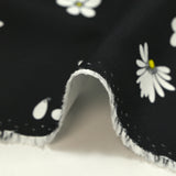 Cotton gabardine with daisy print on black background