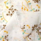 Broderie anglaise colorée marron et rose pâle fond blanc