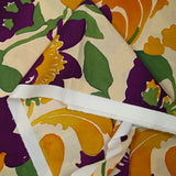 Coton imprimé fleurs orange et violet fond beige