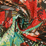 Maille crêpe imprimée patchwork ethnique rouge corail fond marron