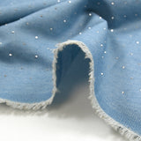 Cotton chambray decorated with rhinestones on a sky blue background