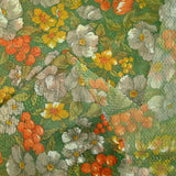 Maille polyester lamée fleurs orange et vert fond vert prairie