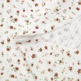 Jersey pointelle coton imprimé envolée de fleurs rose et brique fond blanc cassé