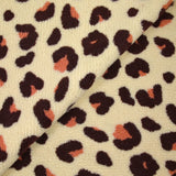 Piel sherpa sintética de leopardo fondo salmón y ciruela crudo