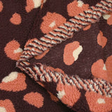 Salmon and ecru leopard faux sherpa fur, dark plum background
