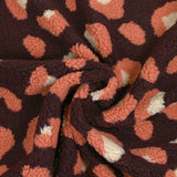 Salmon and ecru leopard faux sherpa fur, dark plum background