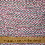 Textured muslin printed with purple and turquoise floral medallions on a white background