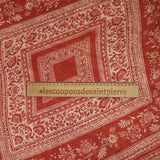 Satin crinkle muslin printed with ecru and brick floral borders