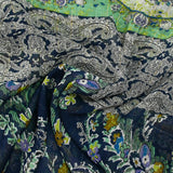 Crinkle chiffon printed with ornamental friezes in sea green and navy background