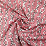 Lightweight polyester satin with white chain link print on pink background