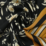Satin polyester twill printed with ecru flowers and ocher border, black background
