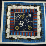 Satin polyester twill printed with red and blue marine knots on a midnight blue background