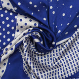 Satin crinkle muslin printed with white and royal blue graphic polka dots
