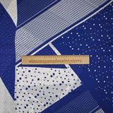 Satin crinkle muslin printed with white and royal blue graphic polka dots