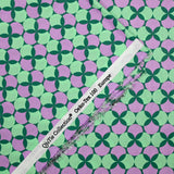 Coated poplin printed with polka dots & purple clover green background