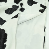 Fausse fourrure poils mi-longs vache noir