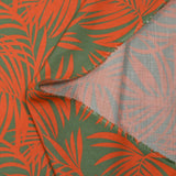 Viscosa estampada hojas tropicales fondo naranja verde