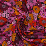 Viscose printed sixties flowers in red, plum and orchid