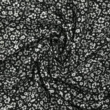 Viscose imprimée myriade de fleurs gris et blanc fond noir