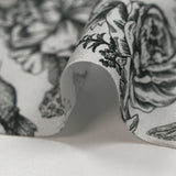 Viscose printed with roses and hummingbirds on a light gray background