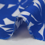 Viscosa estampada con hojas de bambú de color azul sobre fondo blanco