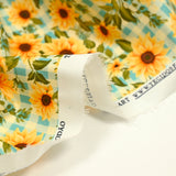 Coton imprimé tournesol fond vichy bleu