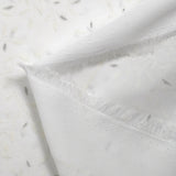 Crêpe georgette floqué paillettes argentées fond blanc