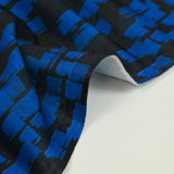 Punto crepe estampado con pintura azul y fondo negro